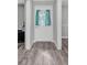 Entryway features wood flooring, a white front door with sidelights and an interior view to the living area at 4825 Foxrun, Lakeland, FL 33813