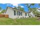 Side view of a charming single-story home with a fenced yard and well-kept landscaping at 4825 Foxrun, Lakeland, FL 33813
