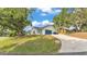 The home features a blue garage door, lush landscaping, and a manicured lawn at 4825 Foxrun, Lakeland, FL 33813