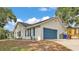Side view of a lovely single-story home with a blue garage door and well-maintained landscaping at 4825 Foxrun, Lakeland, FL 33813