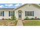 Close up of a charming one-story home with a decorative front door and manicured landscaping at 4825 Foxrun, Lakeland, FL 33813