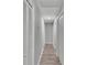 Bright hallway with stylish flooring and white doors on both sides at 4825 Foxrun, Lakeland, FL 33813