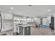 Bright open concept kitchen and living space with modern cabinetry and stainless steel appliances at 4825 Foxrun, Lakeland, FL 33813