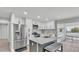 Bright kitchen features stainless appliances, center island, and ample white cabinetry at 4825 Foxrun, Lakeland, FL 33813