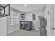 Laundry room with a window, laundry machines, and epoxy floors at 4825 Foxrun, Lakeland, FL 33813