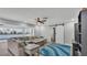 Bright living area features a stylish ceiling fan, large sectional sofa, and sliding barn door at 4825 Foxrun, Lakeland, FL 33813