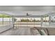 Bright sun room boasts tiled patio views and comfortable seating area for relaxation at 4825 Foxrun, Lakeland, FL 33813