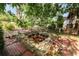 Backyard area with a stone-lined pond and brick pathways at 509 Rob Roy St, Lakeland, FL 33813