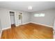 Open bedroom with hardwood floors, closet, and access to a bathroom at 509 Rob Roy St, Lakeland, FL 33813
