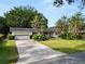 Charming single-story home featuring a lush front lawn and a driveway leading to an attached garage at 509 Rob Roy St, Lakeland, FL 33813