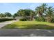 Quaint single-story home with palm trees, green lawn, and attached garage providing curb appeal at 509 Rob Roy St, Lakeland, FL 33813