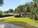 Charming single-story home with a well-manicured lawn and lush tropical landscaping, creating a welcoming curb appeal at 509 Rob Roy St, Lakeland, FL 33813