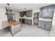 Updated kitchen with gray cabinets, stainless steel appliances, an island and granite countertops at 509 Rob Roy St, Lakeland, FL 33813