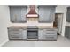 Stylish kitchen featuring gray cabinets, stainless appliances, granite countertops and copper fixtures at 509 Rob Roy St, Lakeland, FL 33813