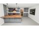 Modern kitchen featuring gray cabinetry, granite countertops, stainless steel appliances and tile flooring at 509 Rob Roy St, Lakeland, FL 33813