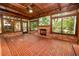 Relaxing sunroom with brick floor, fireplace, wood ceiling, and backyard views at 509 Rob Roy St, Lakeland, FL 33813