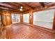 Bright sun room with brick floor, wood-beamed ceiling, and access to multiple rooms at 509 Rob Roy St, Lakeland, FL 33813