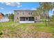 Back exterior view of home showing screened in porch and large grassy yard at 5163 Spanish Oaks Dr, Lakeland, FL 33805