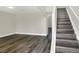 Spacious basement area with stylish wood-look flooring and stairway, perfect for entertaining and relaxing at 5163 Spanish Oaks Dr, Lakeland, FL 33805