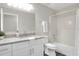 Bathroom featuring white fixtures, a granite countertop vanity, and shower with tub at 5163 Spanish Oaks Dr, Lakeland, FL 33805