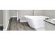 This elegant bathroom features a modern tub, granite countertop, and stylish fixtures at 5163 Spanish Oaks Dr, Lakeland, FL 33805