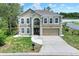 Expansive view of a two-story house showing its landscaping and neighborhood at 5163 Spanish Oaks Dr, Lakeland, FL 33805