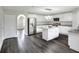 Modern kitchen boasts white cabinetry, granite countertops, stainless steel appliances, and an island at 5163 Spanish Oaks Dr, Lakeland, FL 33805