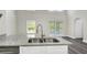 Granite countertops in an open kitchen look out onto a covered patio at 5163 Spanish Oaks Dr, Lakeland, FL 33805