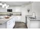 Modern kitchen with white cabinets, stainless appliances, and island with stone countertops at 5163 Spanish Oaks Dr, Lakeland, FL 33805