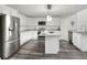 Modern kitchen with stainless steel appliances, grey countertops, white cabinets, and an island at 5163 Spanish Oaks Dr, Lakeland, FL 33805