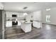 Bright kitchen with stainless appliances, white cabinetry, stone countertops, and open floor plan at 5163 Spanish Oaks Dr, Lakeland, FL 33805