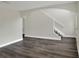 Bright living room features modern flooring, neutral paint, archways and staircase at 5163 Spanish Oaks Dr, Lakeland, FL 33805