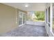Enclosed sunroom featuring tile flooring, neutral wall colors, and natural light creating an inviting extension of the home at 5163 Spanish Oaks Dr, Lakeland, FL 33805
