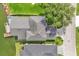 Aerial shot of a home's roof and dock, showcasing lake access and green surroundings at 601 Peninsular Dr, Lakeland, FL 33813