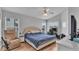 Comfortable bedroom features natural light, a ceiling fan, and light wood flooring at 601 Peninsular Dr, Lakeland, FL 33813