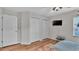 Cozy bedroom features hardwood flooring, a ceiling fan, and two separate closets at 601 Peninsular Dr, Lakeland, FL 33813