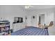 Bright bedroom features a television, neutral walls, ceiling fan, and hardwood floors at 601 Peninsular Dr, Lakeland, FL 33813