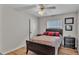 Cozy bedroom with ceiling fan, closet, natural light, and hardwood floors at 601 Peninsular Dr, Lakeland, FL 33813