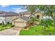 Two-story home with a two-car garage, well-kept lawn and mature trees at 601 Peninsular Dr, Lakeland, FL 33813