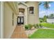 Stunning front entrance with brick pathway, lush landscaping, and double front doors at 601 Peninsular Dr, Lakeland, FL 33813