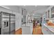 Open kitchen with stainless steel refrigerator and large island with a marble countertop at 601 Peninsular Dr, Lakeland, FL 33813
