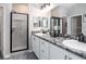 Modern bathroom with dual sinks, granite countertop, and a glass-enclosed shower at 6060 Barracuda Loop, Wimauma, FL 33598