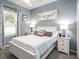 Cozy bedroom with neutral tones features a comfy bed, side tables, and natural light at 6060 Barracuda Loop, Wimauma, FL 33598