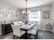 Elegant dining room features marble table, modern chandelier and stylish wall decor at 6060 Barracuda Loop, Wimauma, FL 33598