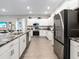 Bright kitchen featuring stainless steel appliances, granite countertops, and recessed lighting at 6060 Barracuda Loop, Wimauma, FL 33598