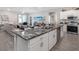 Modern kitchen with a large center island, stainless steel appliances, and an open floor plan at 6060 Barracuda Loop, Wimauma, FL 33598