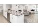 Open-concept kitchen featuring an island with bar seating and stainless steel appliances at 6060 Barracuda Loop, Wimauma, FL 33598