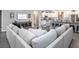 Open-concept living room and kitchen boasts modern appliances, ample seating and a TV at 6060 Barracuda Loop, Wimauma, FL 33598