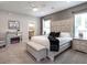Main bedroom features a cozy fireplace, king bed, and ensuite bathroom entrance at 6060 Barracuda Loop, Wimauma, FL 33598
