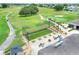 Aerial view of putting green and a covered outdoor seating area with manicured lawns and golf course at 6065 Magpie Dr, Lakeland, FL 33809